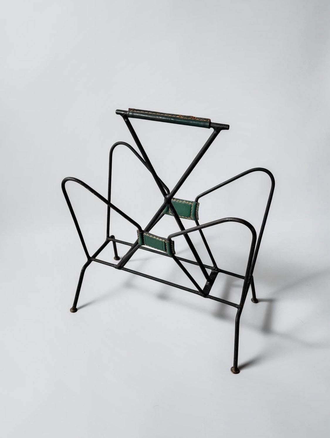 Magazine rack by Jacques Adnet, 1950s
