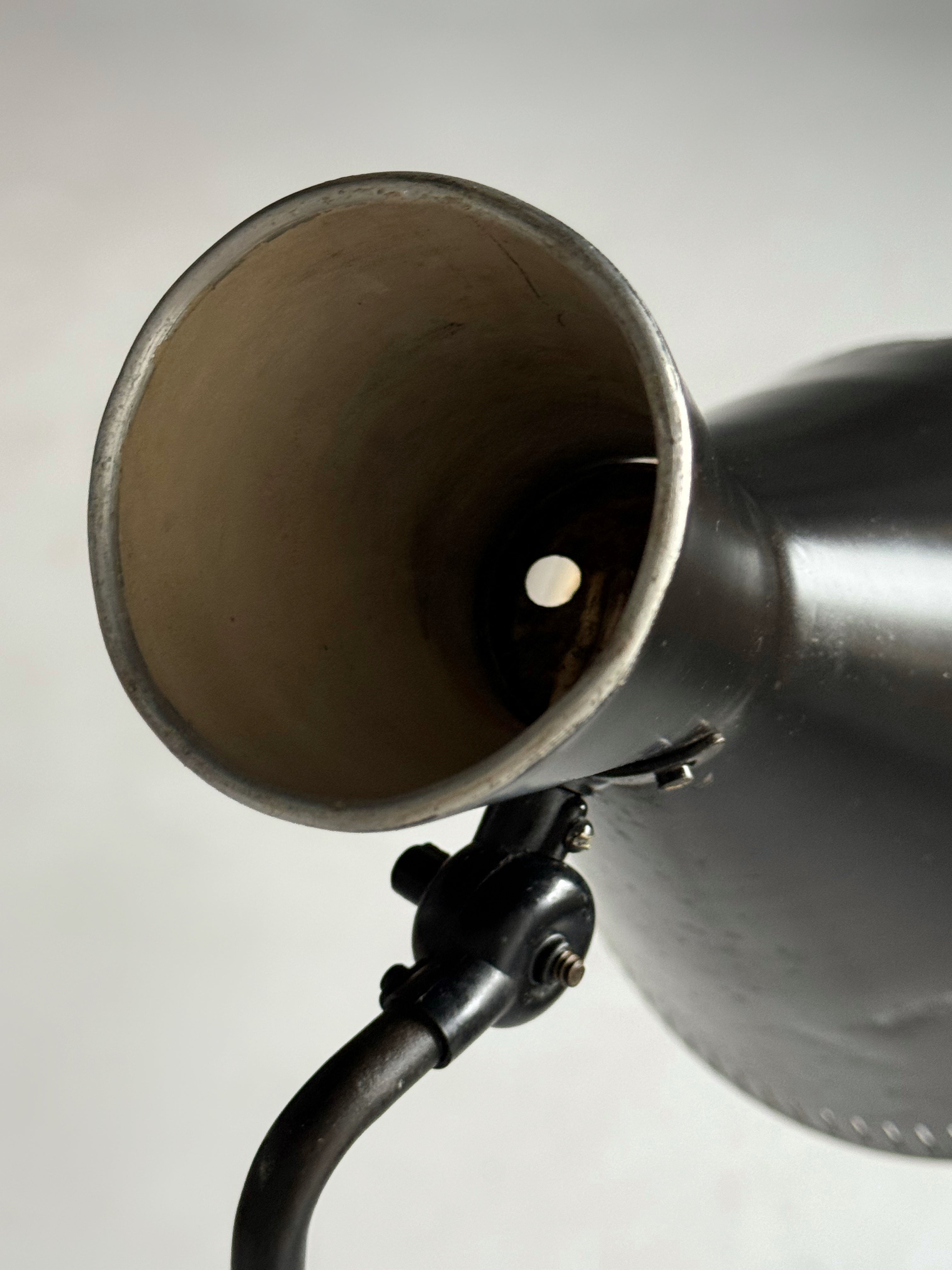 A black lacquered metal floor lamp by Kund Joos-Jensen