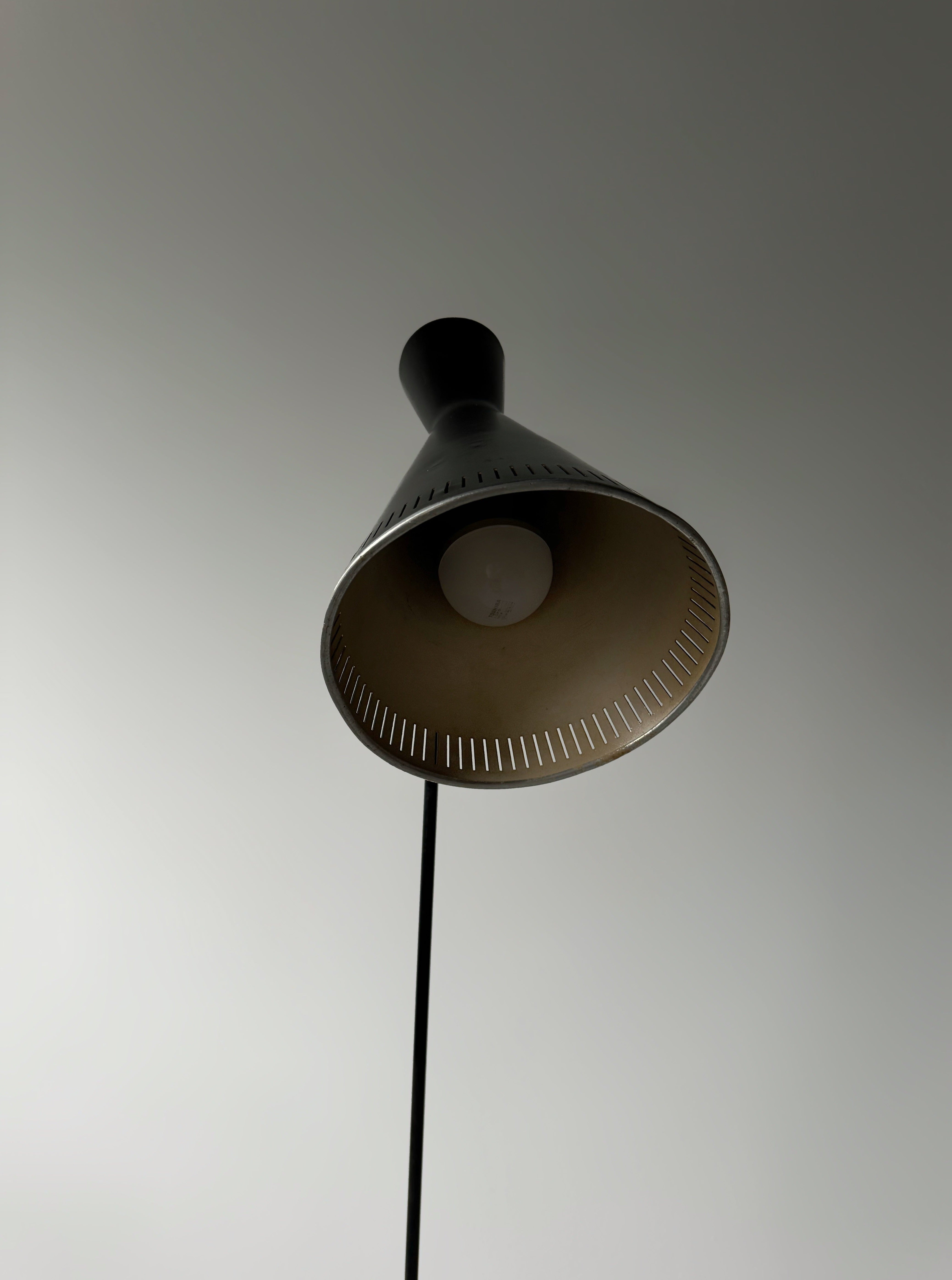 A black lacquered metal floor lamp by Kund Joos-Jensen