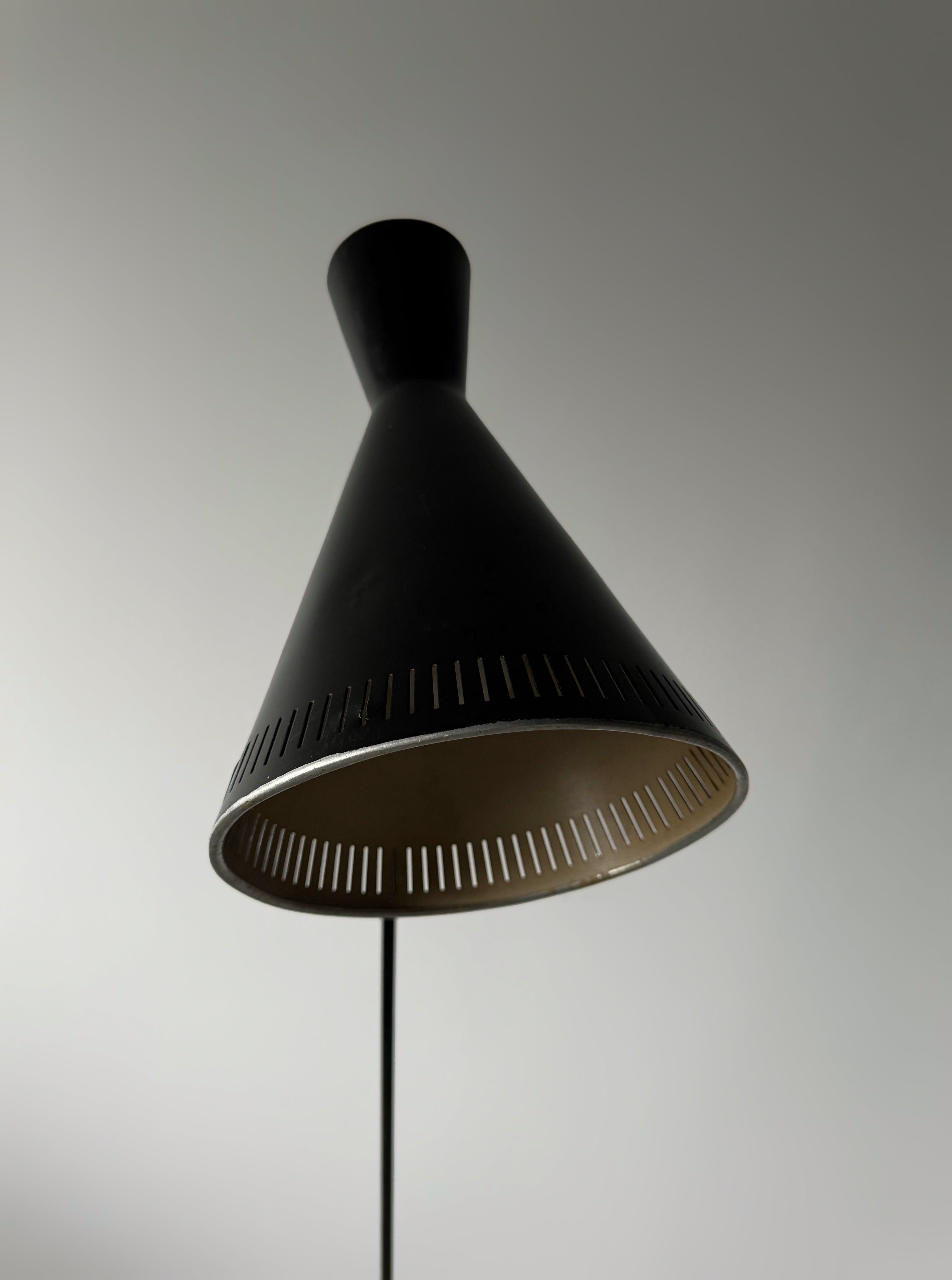 A black lacquered metal floor lamp by Kund Joos-Jensen