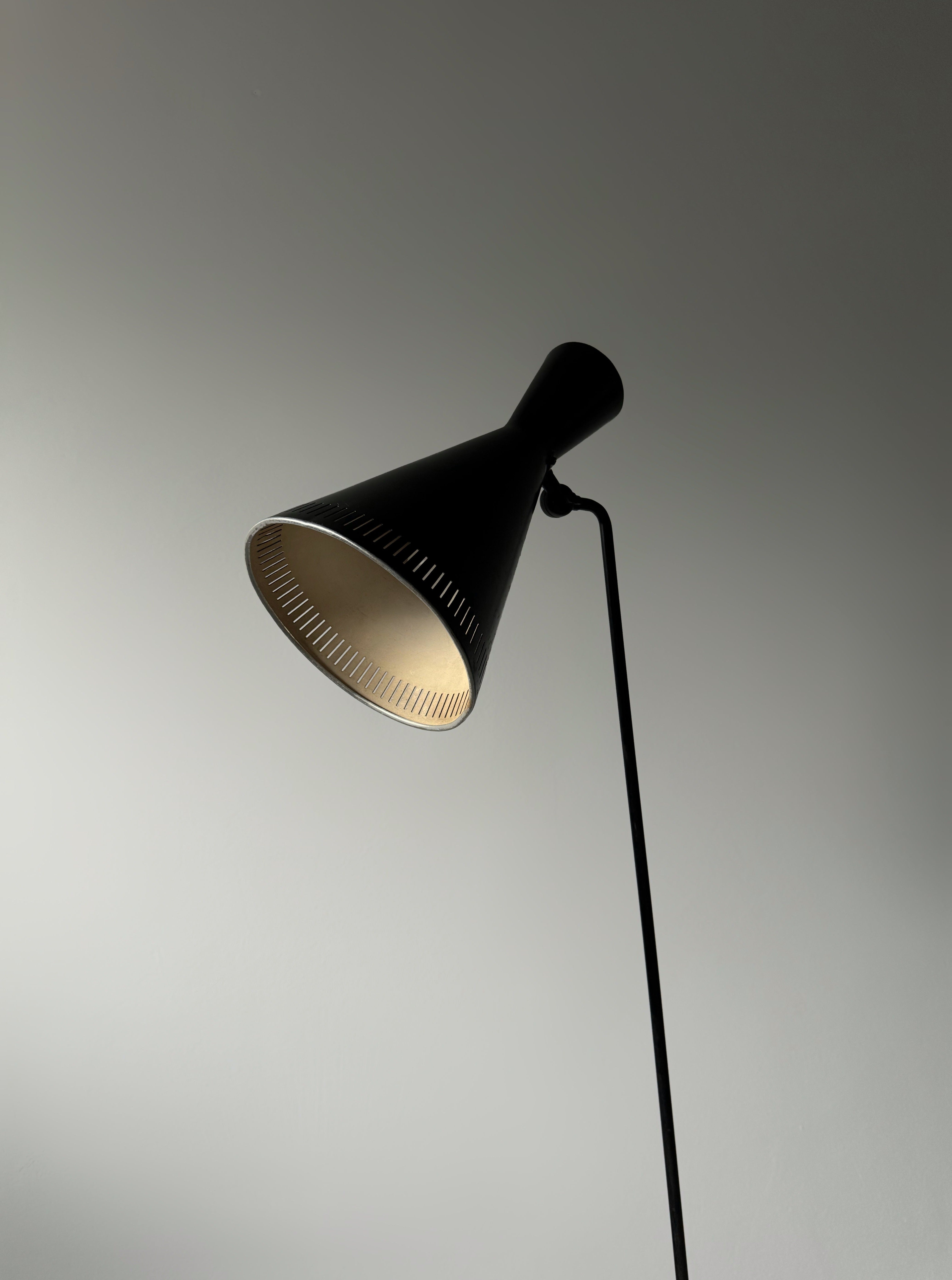A black lacquered metal floor lamp by Kund Joos-Jensen