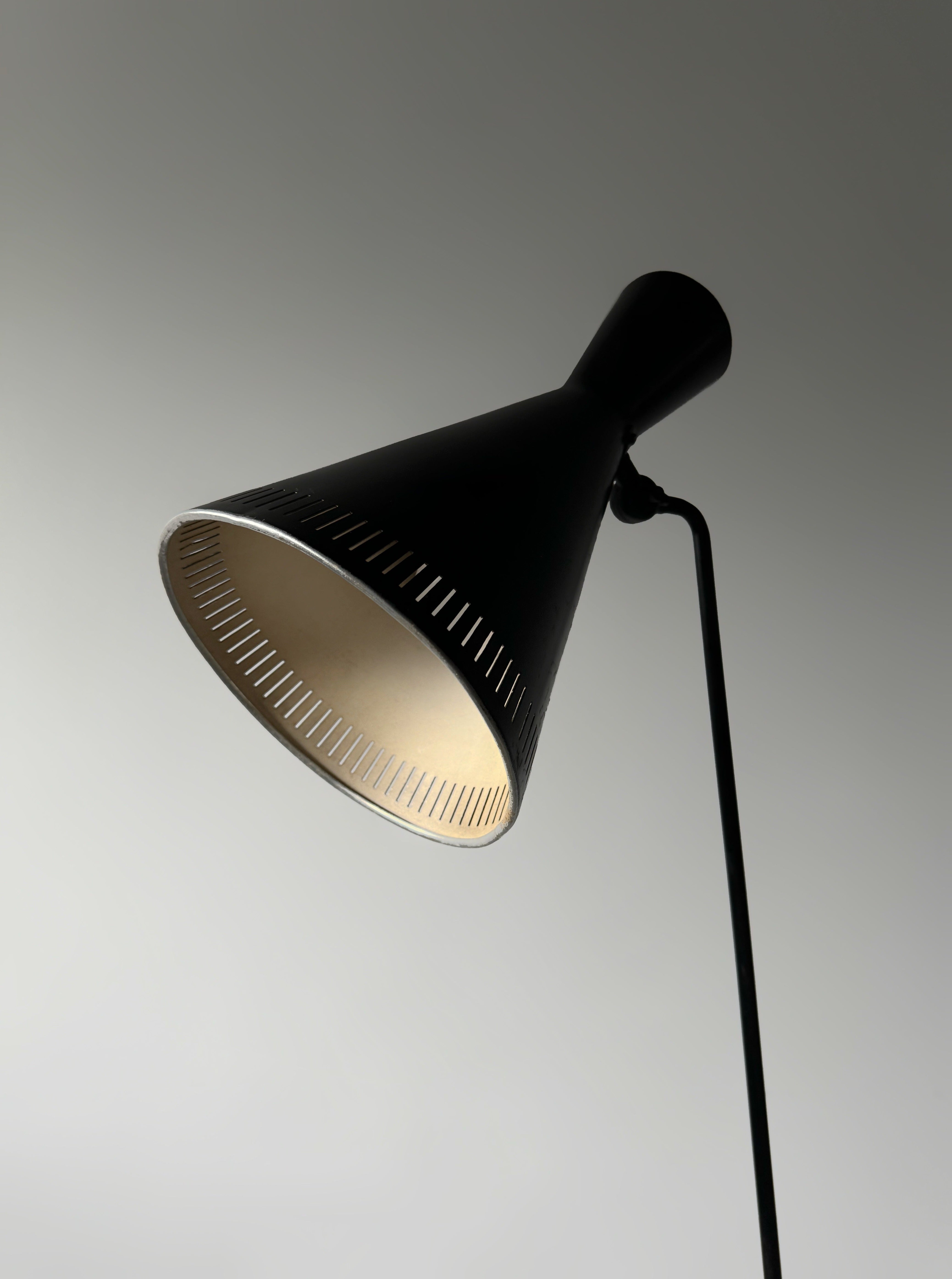 A black lacquered metal floor lamp by Kund Joos-Jensen