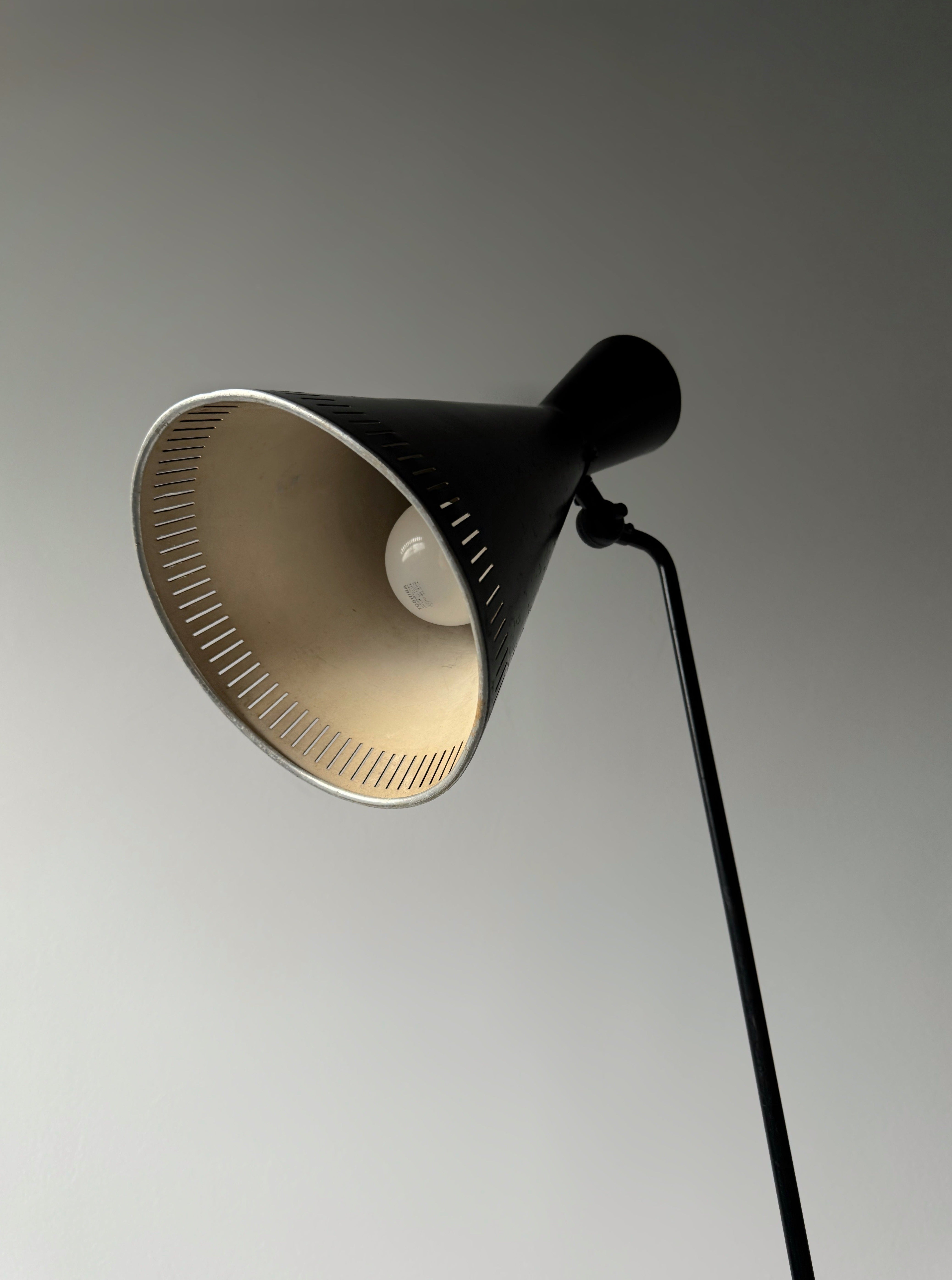 A black lacquered metal floor lamp by Kund Joos-Jensen