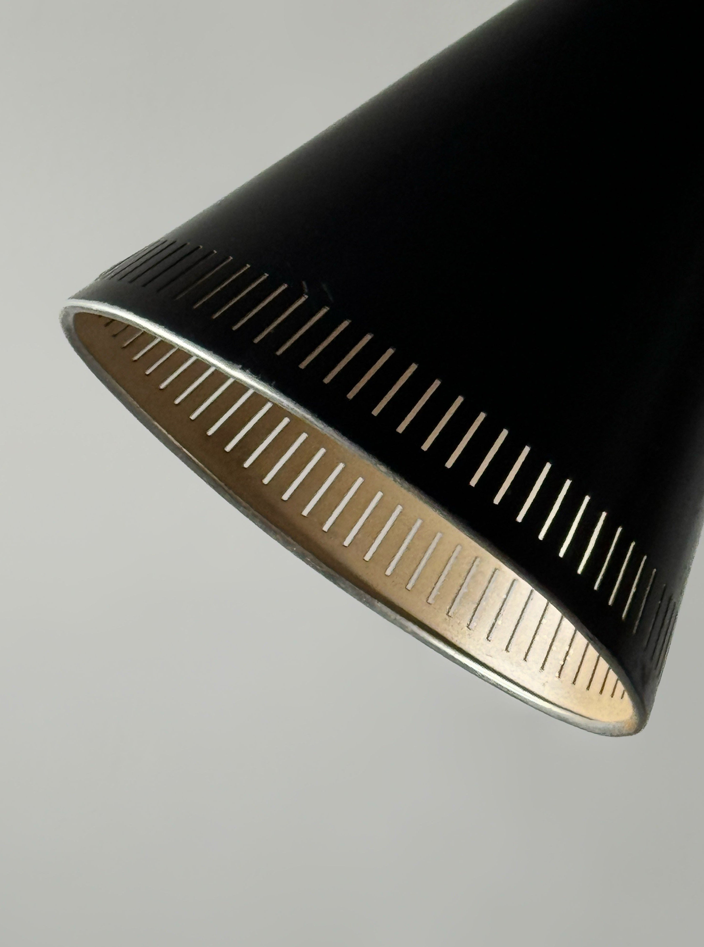 A black lacquered metal floor lamp by Kund Joos-Jensen