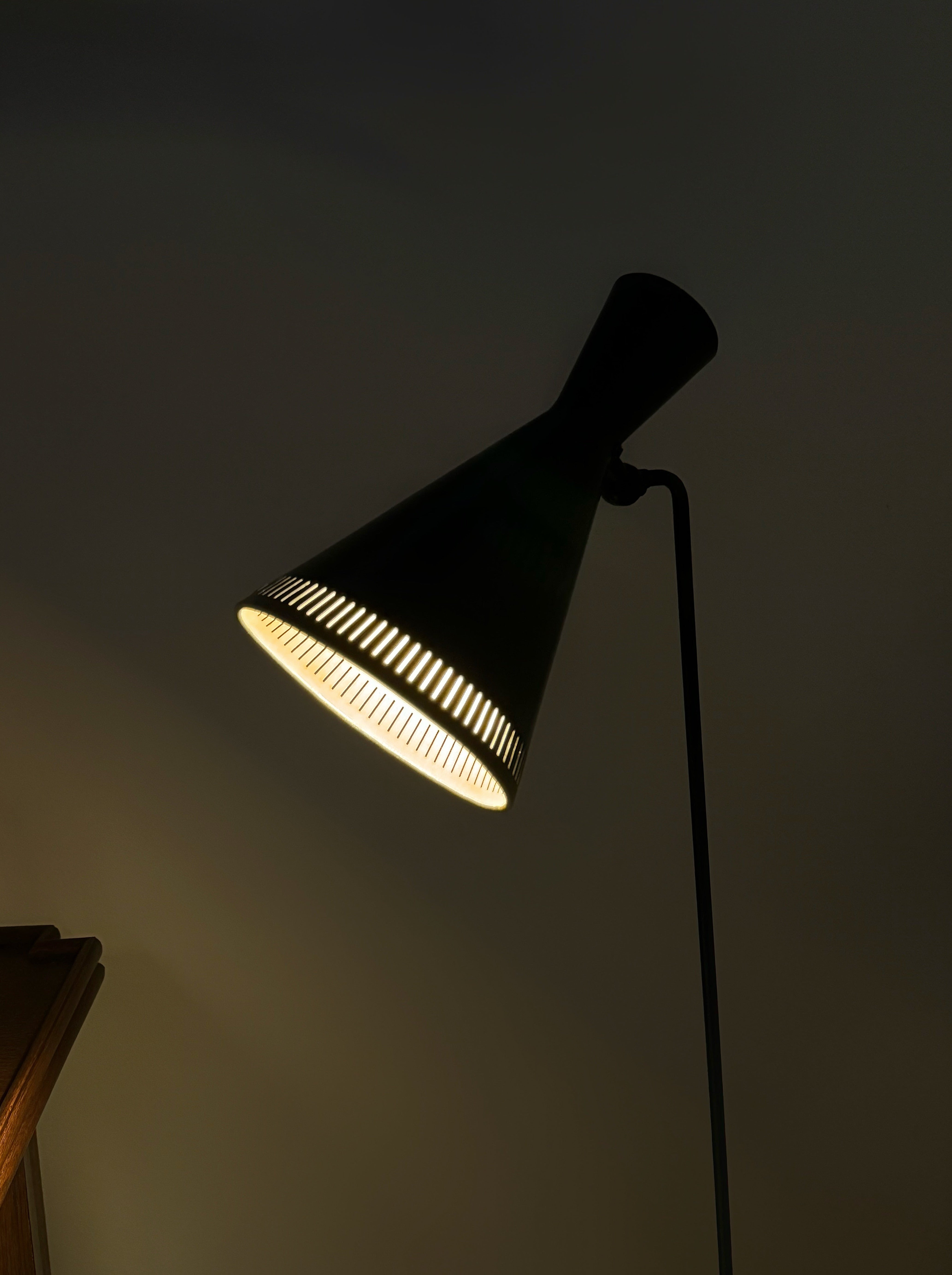 A black lacquered metal floor lamp by Kund Joos-Jensen