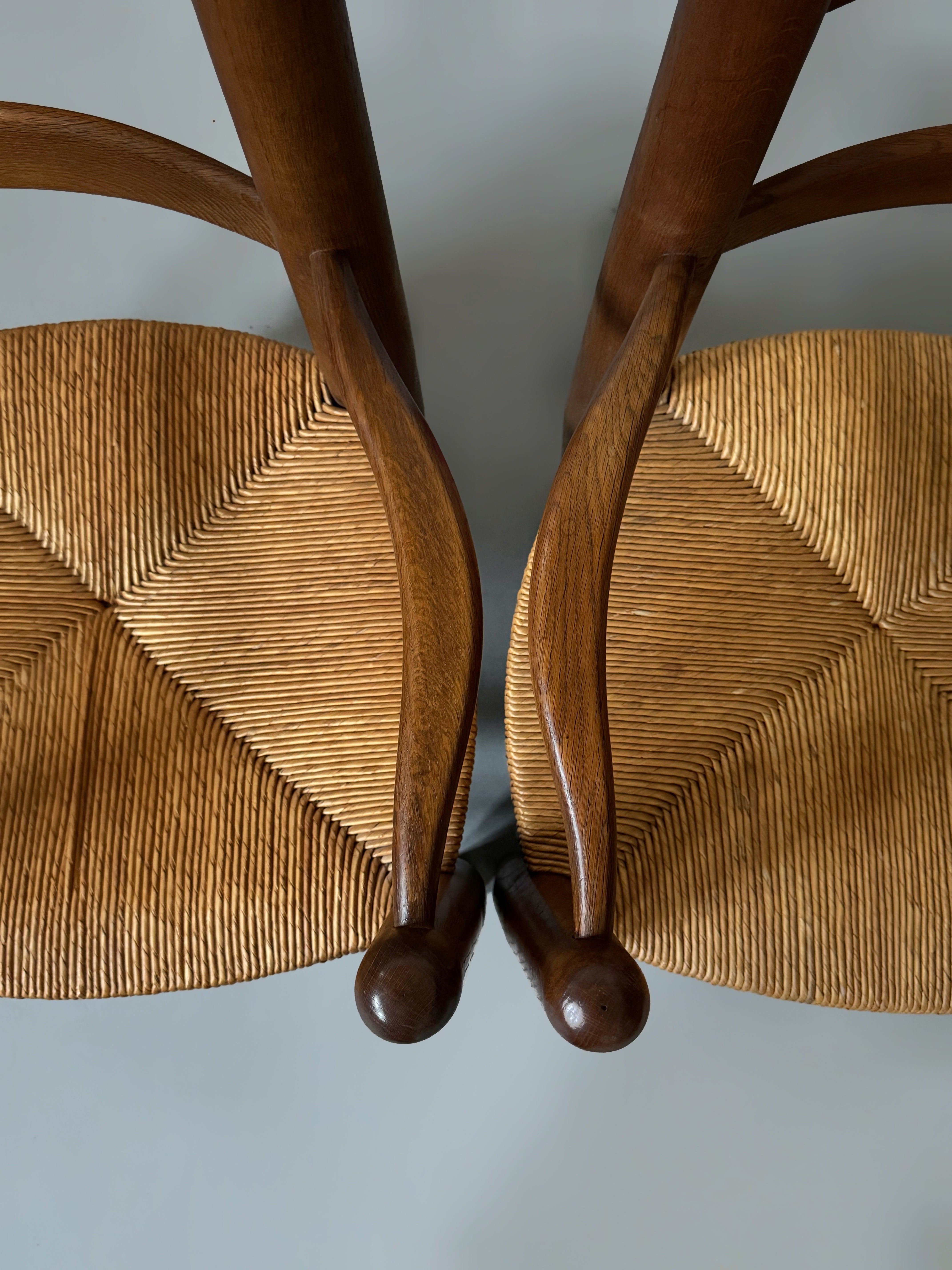 Pair of oak and cane armchairs, France 1950s