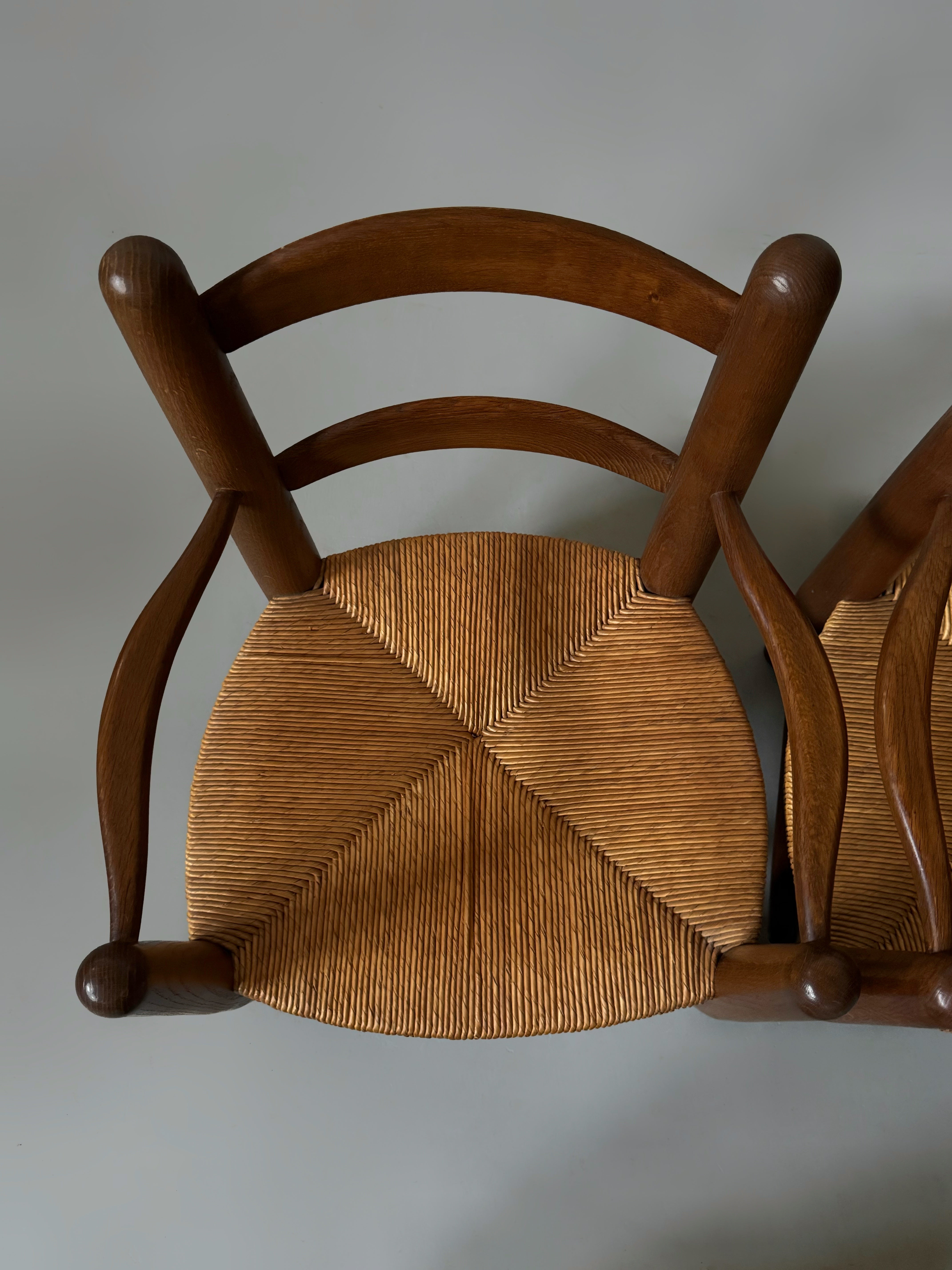Pair of oak and cane armchairs, France 1950s