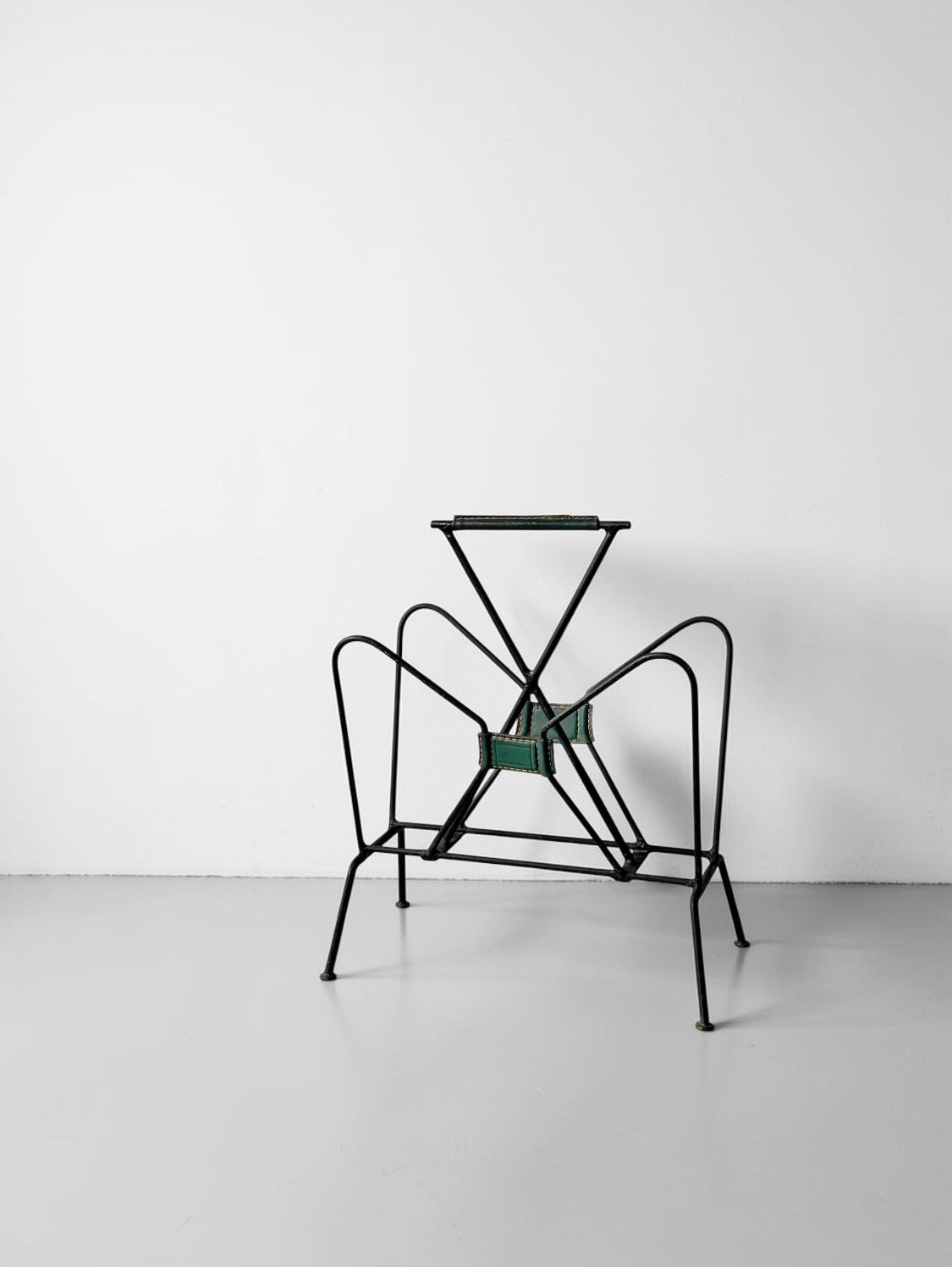 Magazine rack by Jacques Adnet, 1950s