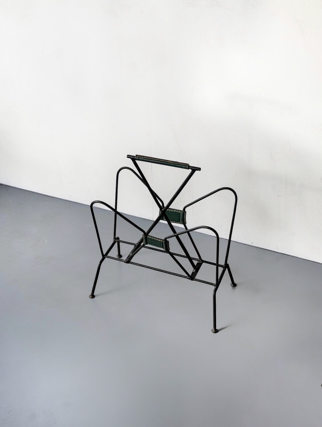 Magazine rack by Jacques Adnet, 1950s