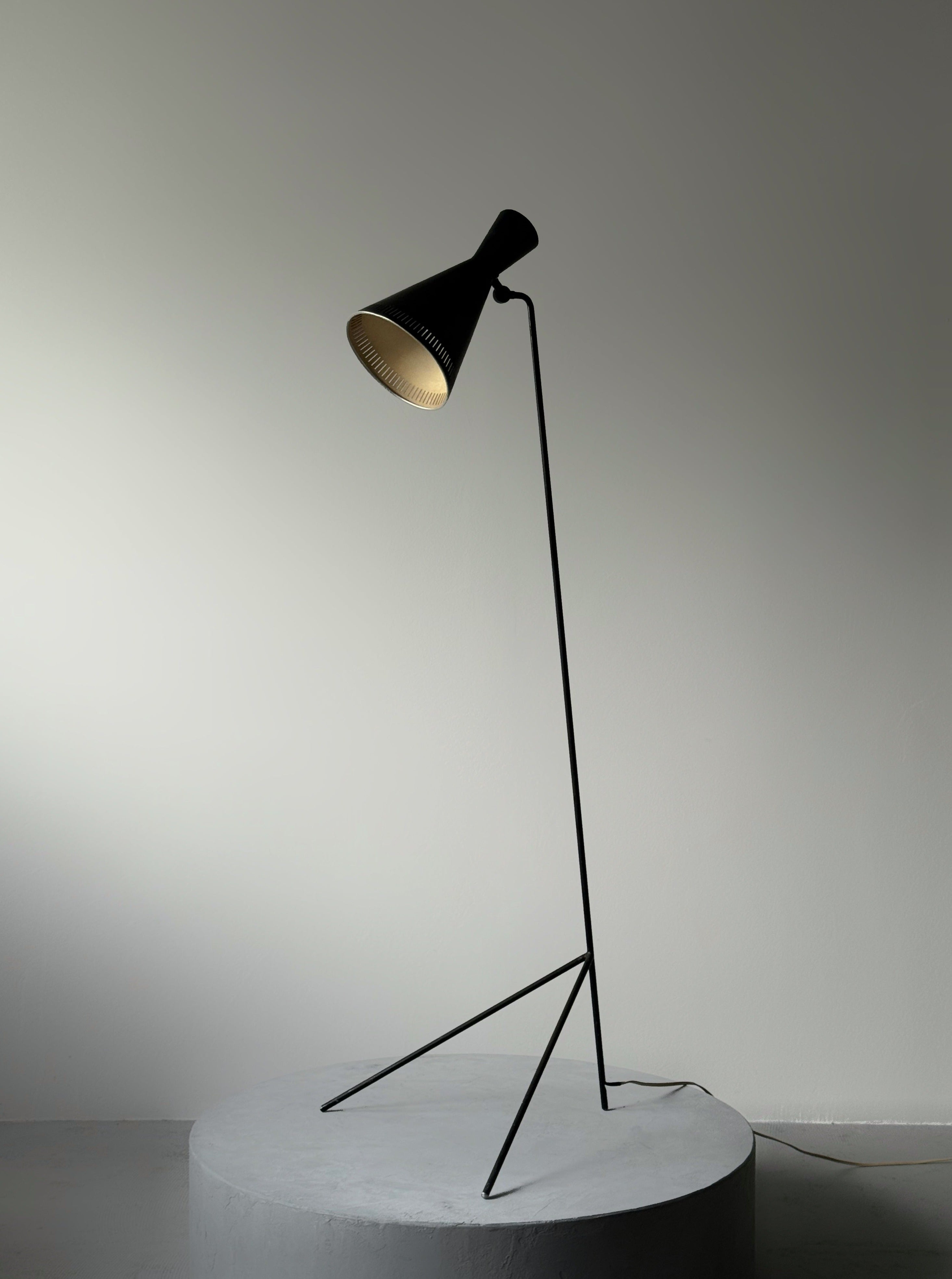 A black lacquered metal floor lamp by Kund Joos-Jensen
