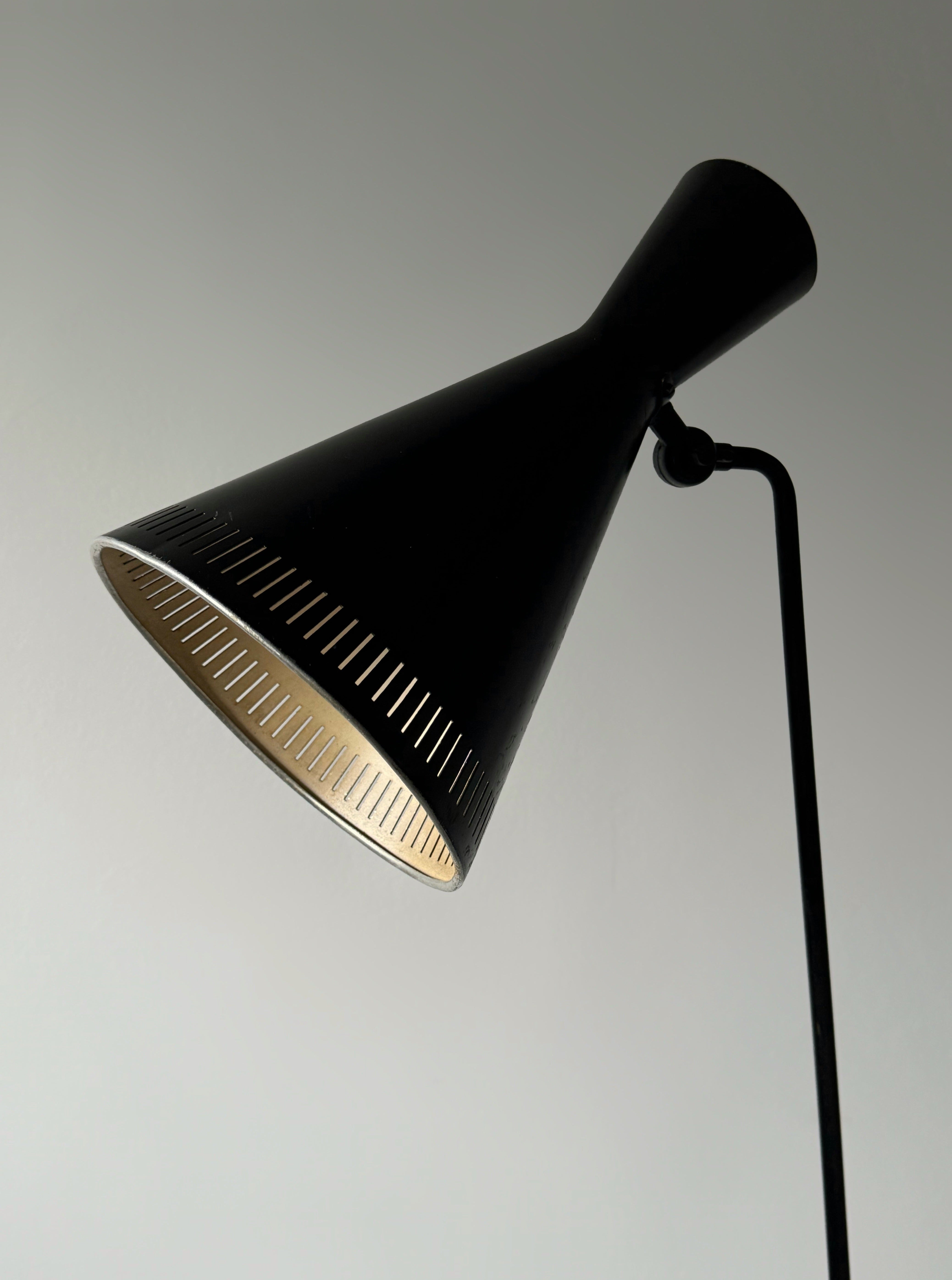 A black lacquered metal floor lamp by Kund Joos-Jensen